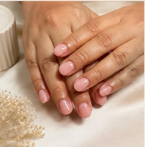 Glossy blush-pink manicure with a clean natural finish